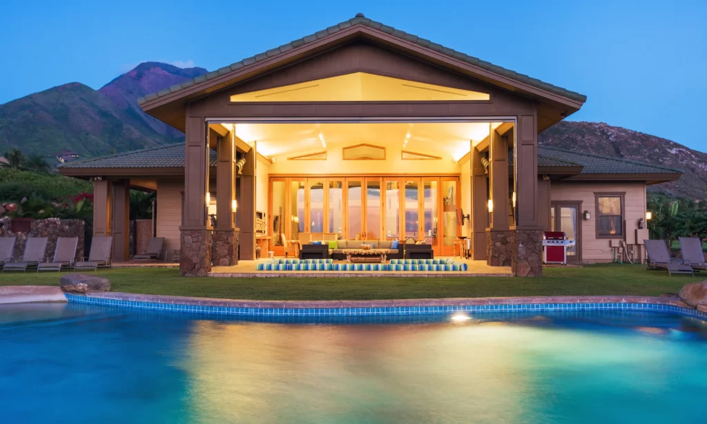 Luxury resort villa illuminated with lux lighting at dusk, showcasing ambient outdoor and indoor lighting transitions.