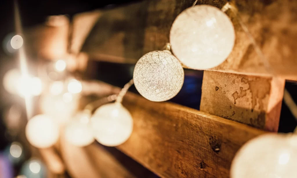 Close-up of decorative sculptural lighting globes mounted on rustic wooden panels.