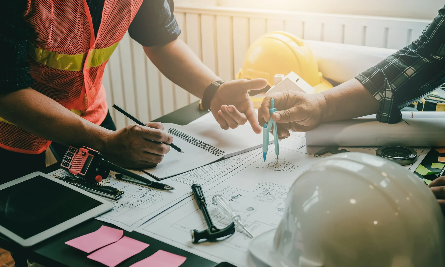 Construction professionals reviewing drawings and specifications for luxury hospitality consulting project coordination
